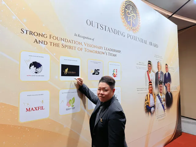 Jay Teh signing the J Elites Group panel on the Outstanding Potential Award wall